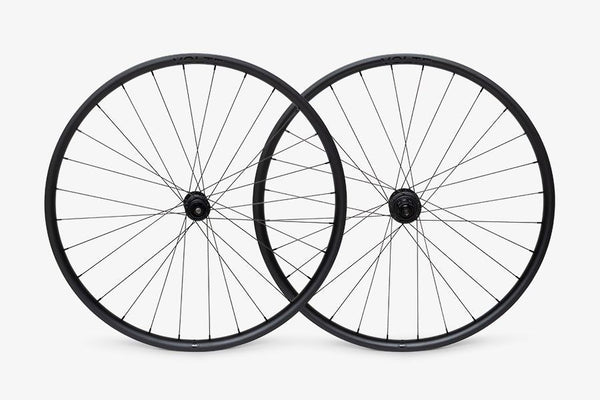 Two bicycle wheels on a white background